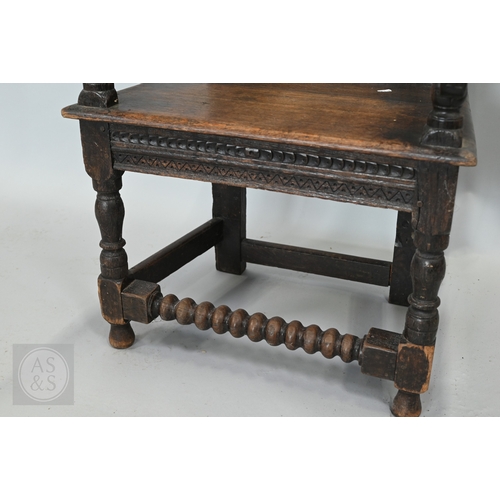 58 - An 19th century and later oak Wainscott armchair, the fielded back panel with twin dragons and folia... 