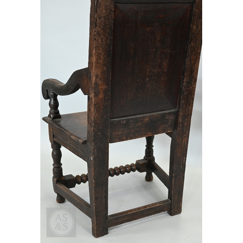 58 - An 19th century and later oak Wainscott armchair, the fielded back panel with twin dragons and folia... 