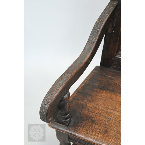 58 - An 19th century and later oak Wainscott armchair, the fielded back panel with twin dragons and folia... 