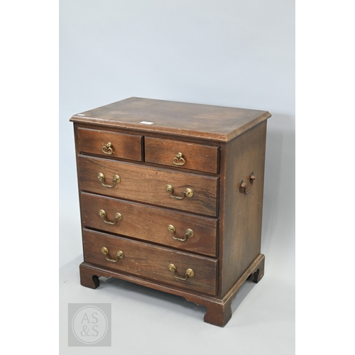 59 - A miniature Georgian style mahogany chest of two short over three long graduated drawers, with brass... 