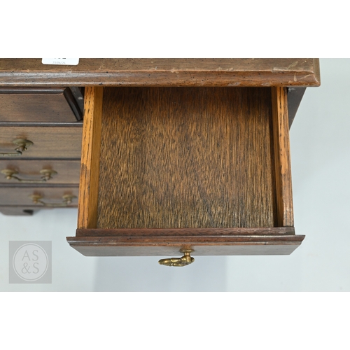 59 - A miniature Georgian style mahogany chest of two short over three long graduated drawers, with brass... 