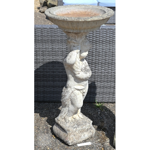 27 - A weathered cast stone cherub figure birdbath, 90 cm h