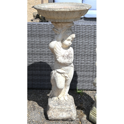 27 - A weathered cast stone cherub figure birdbath, 90 cm h