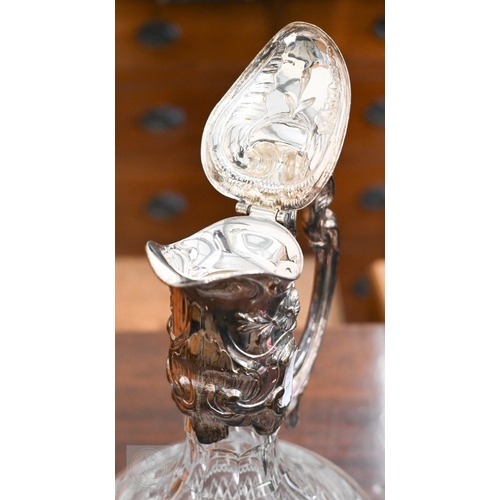 491 - A cut glass claret jug with EP collar, cover and handle, to/w an Art Deco style champagne ice-bucket... 