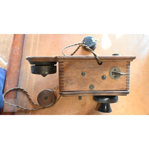 56 - A vintage oak cased railway type wall mounted telephone to/with two associated handsets, a/f