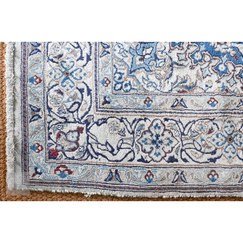 273 - A Persian Nian Shah Abbas design carpet with central medallion and arabesques on blue ground, floral... 
