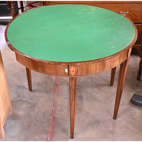 130 - A 19th century mahogany crossbanded demi-lune folding card table on moulded square tapering supports... 