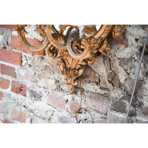 17 - An antique giltwood and gesso girandole mirror in the rococo style, of trefoil form surmounted by a ... 