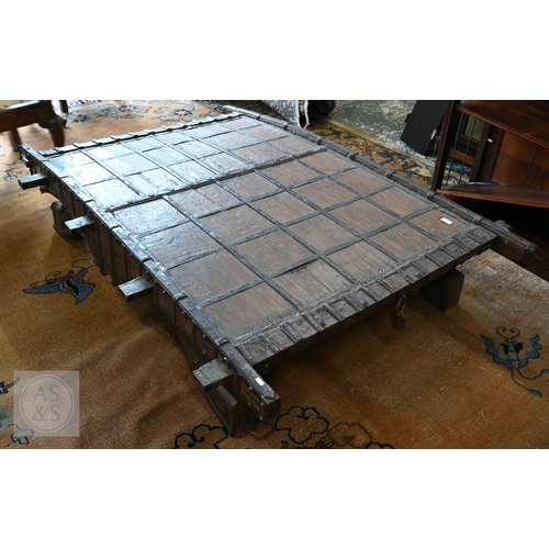 22 - An antique Indian iron bound hardwood ox cart converted to a coffee table, 180 cm x 130 cm x 37 cm h