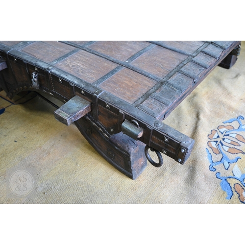 22 - An antique Indian iron bound hardwood ox cart converted to a coffee table, 180 cm x 130 cm x 37 cm h