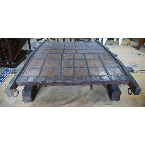 22 - An antique Indian iron bound hardwood ox cart converted to a coffee table, 180 cm x 130 cm x 37 cm h