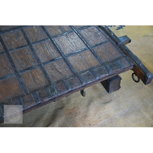 22 - An antique Indian iron bound hardwood ox cart converted to a coffee table, 180 cm x 130 cm x 37 cm h