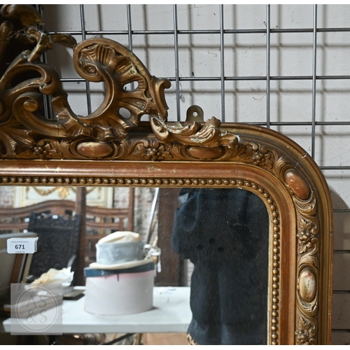 24 - A late 19th century French giltwood framed mirror, surmounted by composite fleur de lys device, 90 c... 