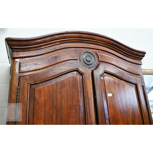 111 - A French Louis XV style provincial armoire with twin panelled doors enclosing a hanging rail and a s... 