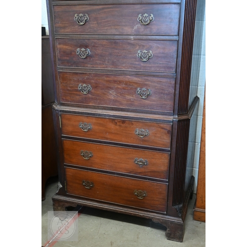 123 - A faux-fronted mahogany chest-on-chest wardrobe, the full length door mimicking stacked drawers encl... 