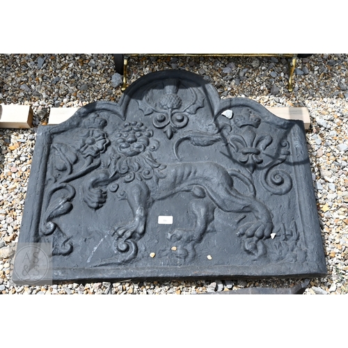 32 - A sand-cast iron fire-back depicting a lion and British National emblems, 66 cm x 79 cm, to/w a pair... 