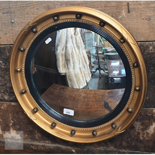 36 - A Regency style gilt convex mirror in ball-mounted gilt frame