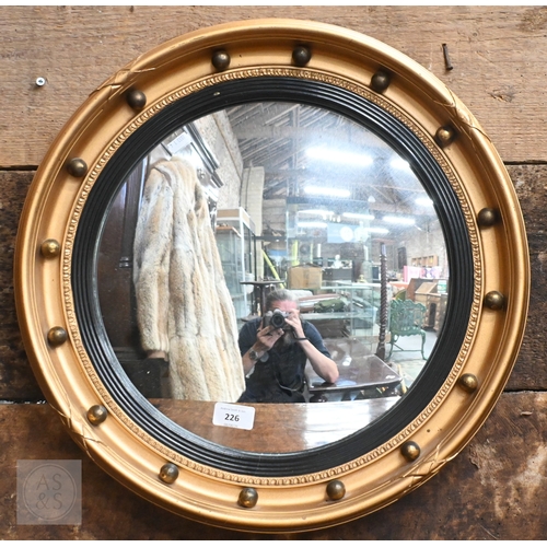 36 - A Regency style gilt convex mirror in ball-mounted gilt frame