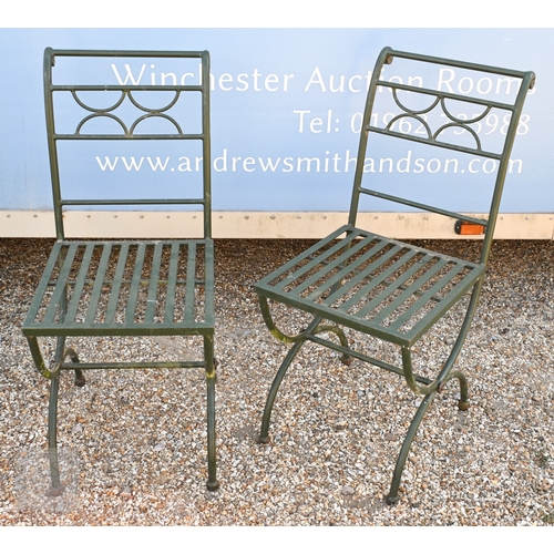 10 - An oval wrought steel oval garden table with rustic wood plank top, to/with a set of four steel chai... 