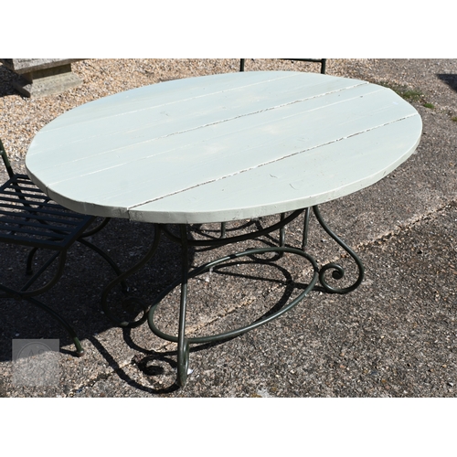10 - An oval wrought steel oval garden table with rustic wood plank top, to/with a set of four steel chai... 