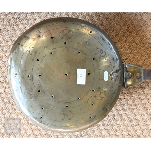 11 - A 17th century iron and brass warming pan, with chased decoration, complete, original, old repair to... 