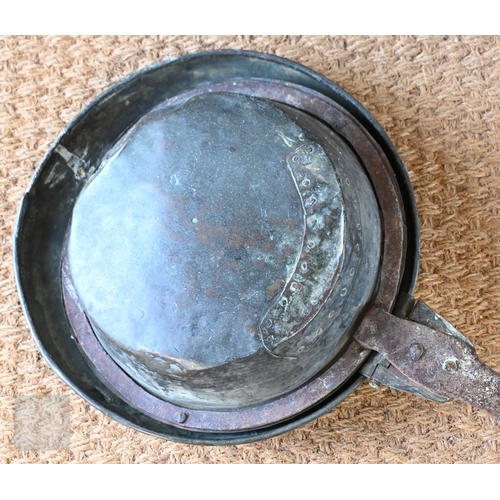 11 - A 17th century iron and brass warming pan, with chased decoration, complete, original, old repair to... 