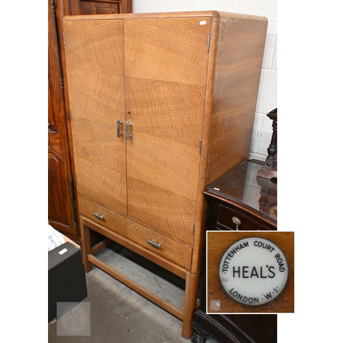 112 - A Heal & Son Art Deco storage cabinet in book-matched oak veneer with chrome-plated handles, the... 
