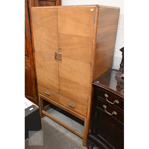 112 - A Heal & Son Art Deco storage cabinet in book-matched oak veneer with chrome-plated handles, the... 