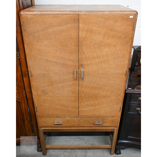 112 - A Heal & Son Art Deco storage cabinet in book-matched oak veneer with chrome-plated handles, the... 