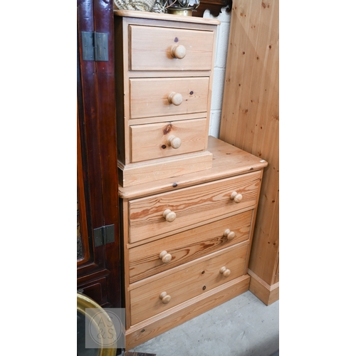 121 - A modern waxed pine child's bedroom suite, comprising small wardrobe with full length panelled doors... 