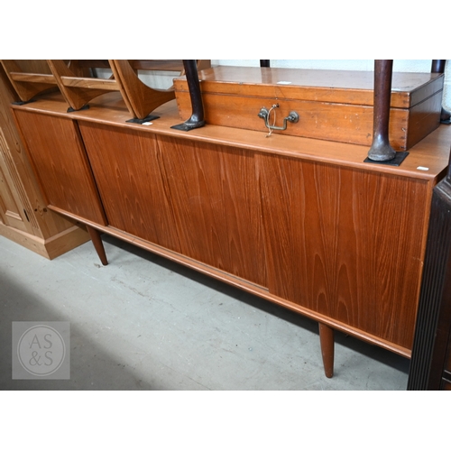 122 - A Mid-Century Danish teak sideboard, four sliding doors enclosing shelves and drawers, raised on tap...