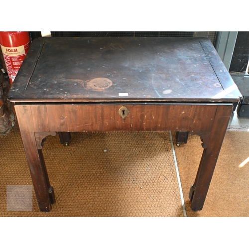 14 - A Georgian mahogany Chippendale period architect's table, on roller castors, heavily distressed over... 