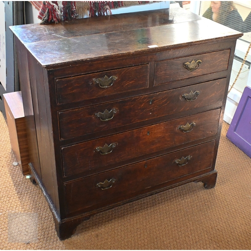 15 - An 18th century boarded oak chest of two short over three long graduated drawers, later brass fittin... 