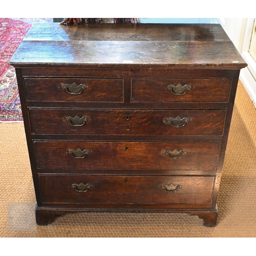 15 - An 18th century boarded oak chest of two short over three long graduated drawers, later brass fittin... 