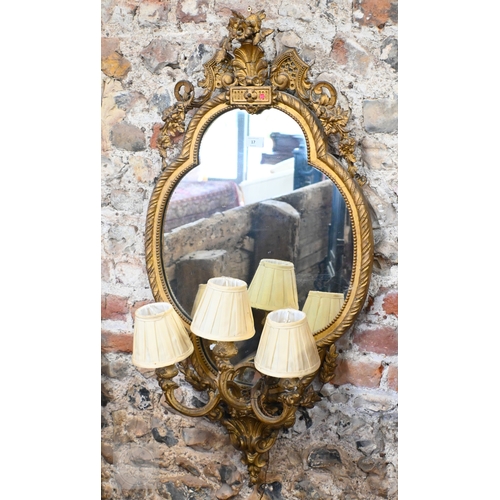 17 - An antique giltwood and gesso girandole mirror in the rococo style, of trefoil form surmounted by a ... 
