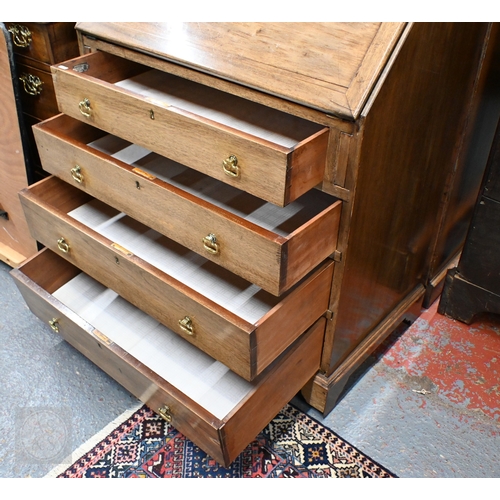 20 - # A compact mahogany bureau, with basic fitted interior over four long graduated drawers, raised on ... 