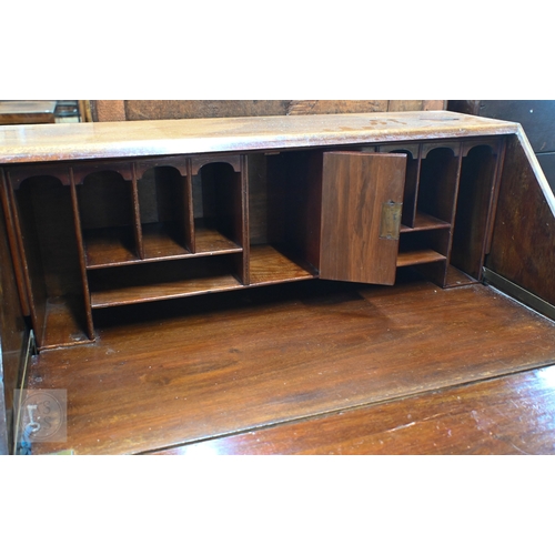 20 - # A compact mahogany bureau, with basic fitted interior over four long graduated drawers, raised on ... 