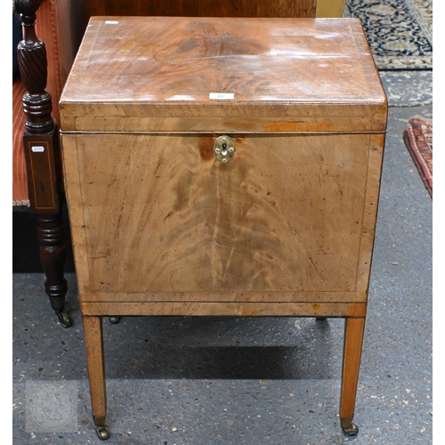 21 - A Victorian mahogany cellarette, the interior with removeable carrier, raised on square supports to ... 