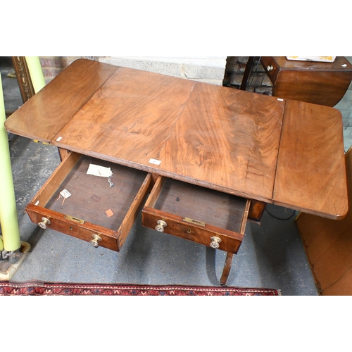 25 - A Victorian mahogany two drawer sofa table with drop ends raised on trestle ands and brass castors