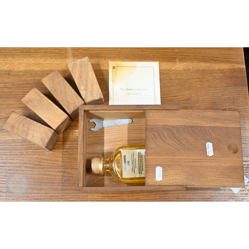 29 - A contemporary extending oak dining table, raised on square legs with detachable ends, by Baltic Fur... 