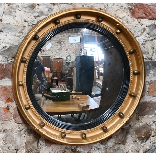 36 - A Regency style gilt convex mirror in ball-mounted gilt frame