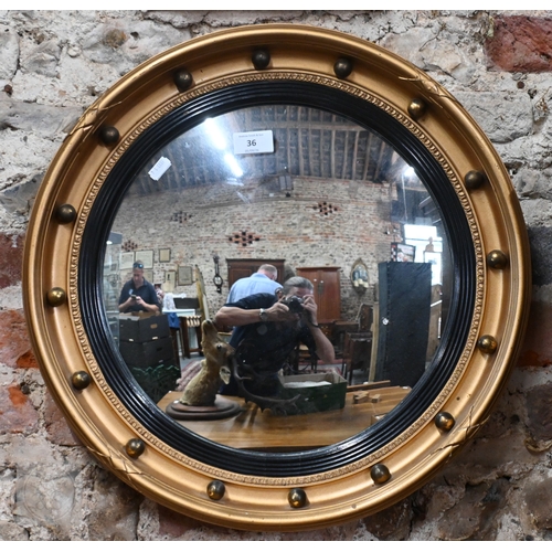 36 - A Regency style gilt convex mirror in ball-mounted gilt frame