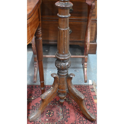 39 - A Regency mahogany double sided tripod music stand, the adjustable easels with fret cut lyre panel r... 