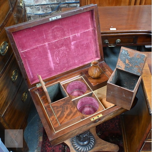 42 - A Regency figured mahogany sarcophagus form teapoy, the interior with four canisters flanking twin c... 