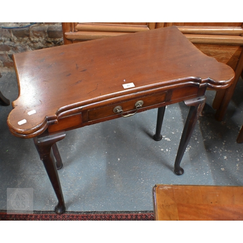 43 - A Georgian style mahogany fold-over gateleg card table. with lobed corners over a frieze drawer, rai... 