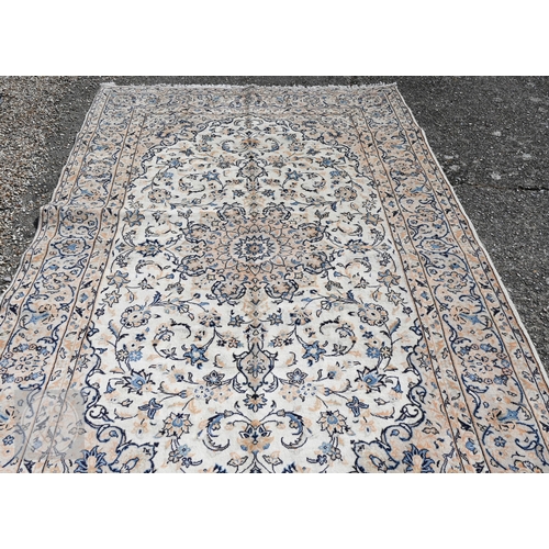 464 - A central Persian Kashan carpet, the ivory ground with trailing flowering vines in blues, 313 cm x 2... 