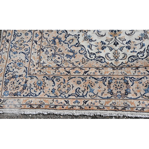 464 - A central Persian Kashan carpet, the ivory ground with trailing flowering vines in blues, 313 cm x 2... 