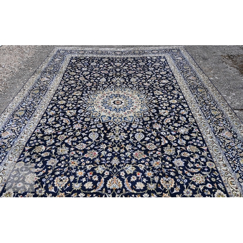 465 - A contemporary central Persian Kashan carpet, signed by the weaver, the blue ground with flowering v... 