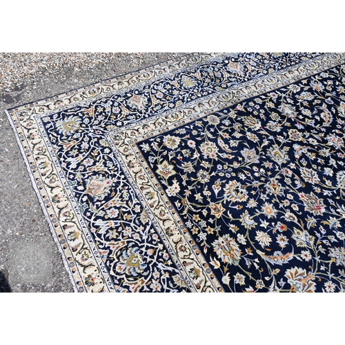 465 - A contemporary central Persian Kashan carpet, signed by the weaver, the blue ground with flowering v... 
