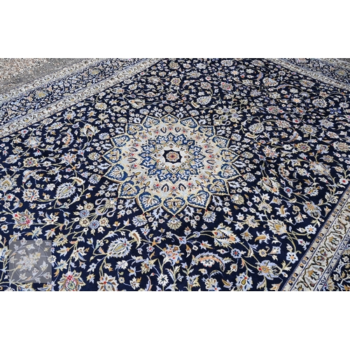 465 - A contemporary central Persian Kashan carpet, signed by the weaver, the blue ground with flowering v... 